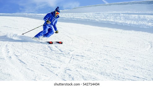 Young Athlete Skiing In Deux Alps French Mountains On Sunny Day - Skier Riding Down For Winter Snow Sport Competition - Training And Vacation Concept - Warm Vivid Filter 