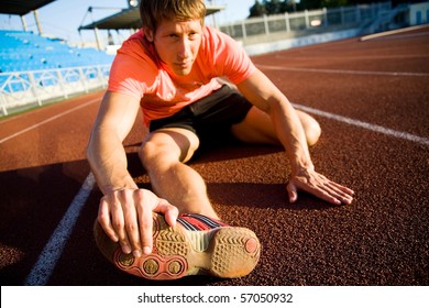 Young Athlete Stretching On The Treadmill Stadium