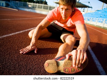 Young Athlete Stretching On The Treadmill Stadium