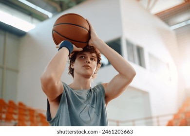 Young athlete taking a shot during basketball practice. Copy space.  - Powered by Shutterstock