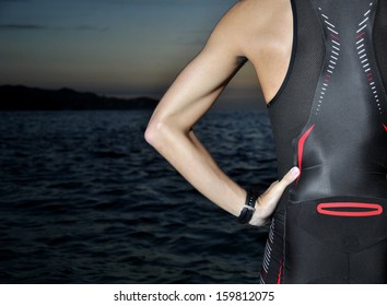 young athlete triathlon in front of a sunrise over the sea