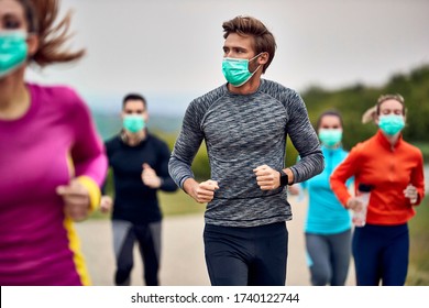 Young Athlete Wearing Protective Face Mask While Running Marathon During Virus Epidemic. 