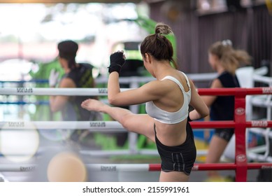 Young Athlete Woman Doing Kick Boxing Training A Martial Arts In Fitness Sport Gym Or Sports Center With A Trainer In Thailand. Boxing, Fitness, Sport, Exercise, Workout Slim And Muay Thai Concept.