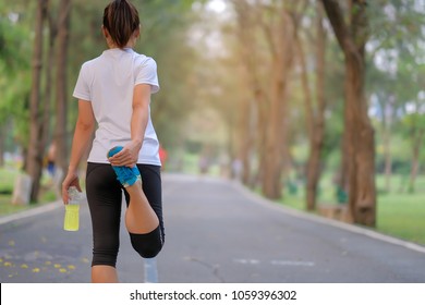 Young Athlete Woman Streching In The Park Outdoor, Female Runner Warm Up Ready For Jogging On The Road Outside, Asian Fitness Walking And Exercise On Footpath In Morning. Wellness And Sport Concepts