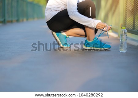 Similar – Young woman stretching legs before training outdoors