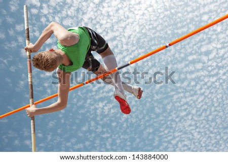 Young athletes pole vault seems to reach the sky