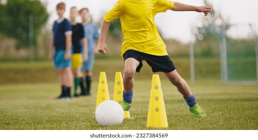 Young Athletes Show Their Skills in Dynamic Soccer Training Session. Boys on Football Practice Slalom Drill During Summer Camp - Powered by Shutterstock