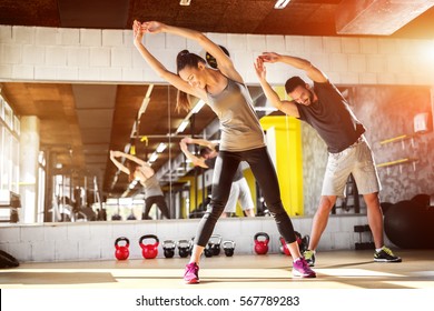 Young athletes stretching at the gym. - Shutterstock ID 567789283