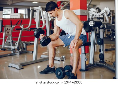 A young and athletic boy is engaged in sports in the gym - Shutterstock ID 1344763385