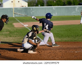 Young athletic boys playing in a competitive game of baseball - Powered by Shutterstock