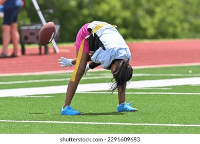 Young athletic children playing in a competitive flag football game - Powered by Shutterstock