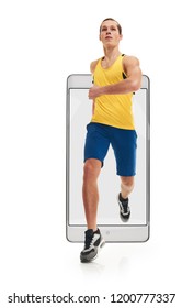 Young Athletic Concentrated Sportive Man Running Marathon, Concept Virtual Reality Of The Smartphone. Going Out Of The Device