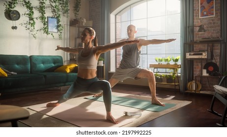 Young Athletic Couple Exercising, Stretching and Practising Yoga in the Morning in Bright Sunny Home Living Room. Healthy Lifestyle, Fitness, Wellbeing and Mindfulness Concept. - Powered by Shutterstock