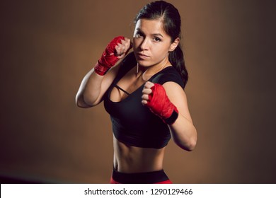 Young Athletic Girl Fighter Trains In The Gym.