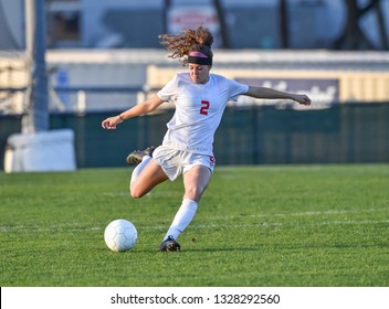 Young athletic girl playing soccer