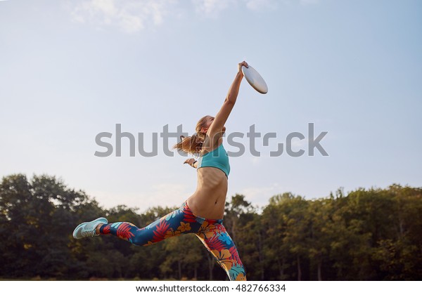 Young athletic\
girl playing ultimate\
frisbee