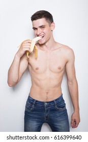 Young Athletic Guy Eating A Banana