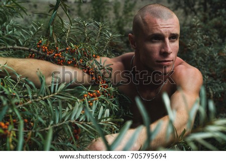 Young athletic guy on the beach