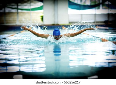 Young athletic man with butterfly swimming technique