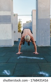 Young Athletic Man Doing Burpee On Parkour Area. Training Alone Outdoors.