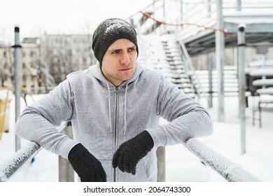 Young Athletic Man Doing Dips On A Parallel Bars During His Outdoor Winter Workout