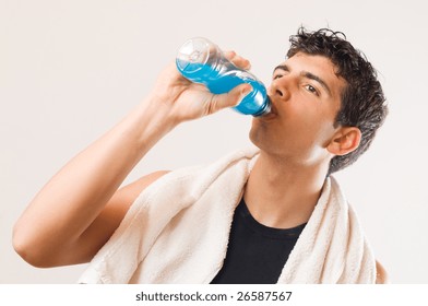 Young Athletic Man Drinking Energy Drink After His Exercising At Gym