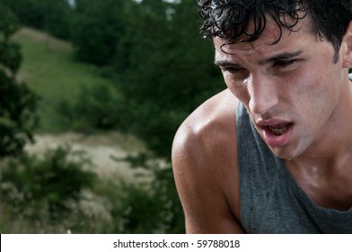 Young athletic man taking a break during a challenging jogging outdoor