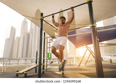 Young athletic man training outdoors - Young adult doing a fitness workout - Powered by Shutterstock