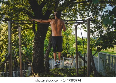 Young Athletic Men Doing One Arm Pull Ups At Backyard Gym, DIY Structure For Fitness, Pull Up Bar 