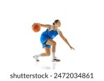 Young athletic woman, basketball player in sportswear preparing to jump to make perfect shot against white studio background. Concept of professional sport, championship, tournament, hobby.