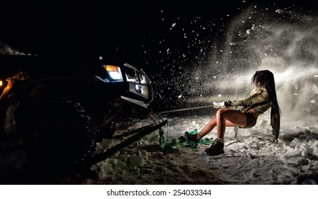 Young Athletic Woman Pulling Car In Winter