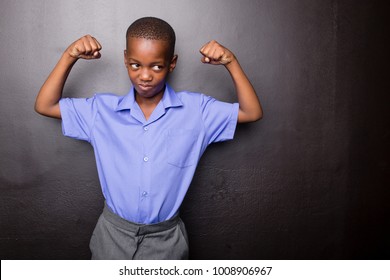 Young Atractive Black Boy Wearing School Unifor Looing Sad And Worried Going To School For The First Time With His Arms In A Muscle Flexing Gesture..