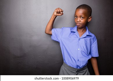 Young Atractive Black Boy Wearing School Unifor Looing Sad And Worried Going To School For The First Time With His One Arm Making Flexing His Muscle.