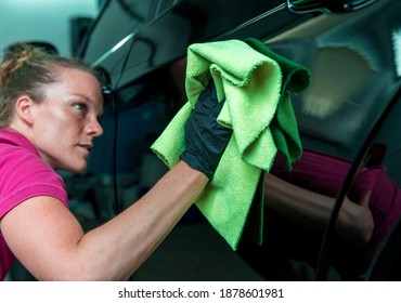 Young Atractive Woman Polishing Car Body In Service