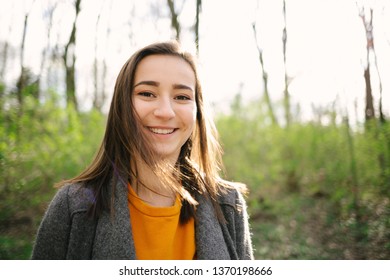 Young And Attracive Woman Standing And Laughing In The Woods. Lifestyle,health And Enviromental Protection Concept. Vintage Analog Film Look.