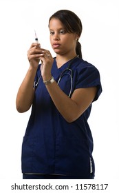 Young Attractive African American  Woman Healthcare Worker Wearing Dark Blue Scrubs And A Stethoscope Holding And Looking At A Syringe