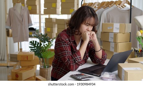 Young Attractive Asia Female Hipster Thoughtful Serious Doubtful Feeling Stress Worry With Financial Problem In SME Crisis Small Business Challenges Impact From Covid Coronavirus At Home Office.