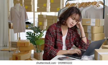 Young Attractive Asia Female Hipster Thoughtful Serious Doubtful Feeling Stress Worry With Financial Problem In SME Crisis Small Business Challenges Impact From Covid Coronavirus At Home Office.