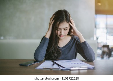 Young attractive Asian business woman sleeping, drowsing or taking a nap at her desk, Tired business woman accountant with bills and paper folders in office, tired young business woman with laptop. - Shutterstock ID 1101922520