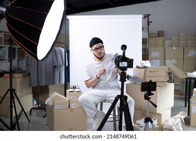 Young attractive Asian man blogger or vlogger looking at camera reviewing product. Modern businessman using social media for marketing. Business online influencer on social media concept. - Shutterstock ID 2148749061