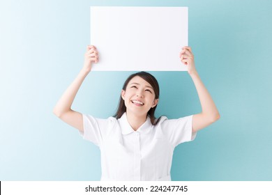 Young Attractive Asian Nurse  Holding Blank White Board