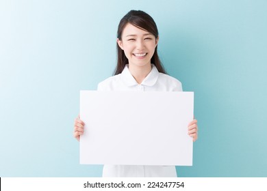 Young Attractive Asian Nurse  Holding Blank White Board