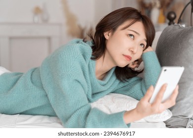 young attractive asian woman ,　think - Shutterstock ID 2394676917