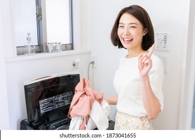 Young Attractive Asian Woman Doing The Laundry