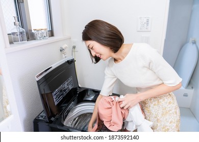 Young Attractive Asian Woman Doing The Laundry