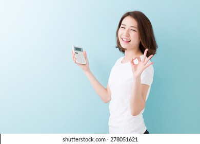 young attractive asian woman having an electronic calculator