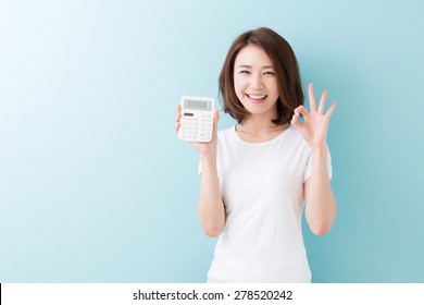 Young Attractive Asian Woman Having An Electronic Calculator