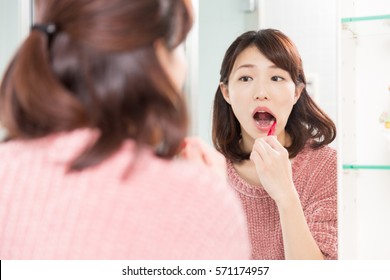 Young Attractive Asian Woman With Healthy Teeth Holding A Tooth Brush