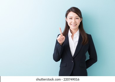 young attractive asian woman indicating the number two