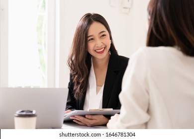 A Young Attractive Asian Woman Is Interviewing For A Job. Her Interviewers Are Diverse. Human Resources Manager Conducting Job Interview With Applicants In Office